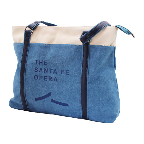 Image of a blue and cream bag with dark blue straps and a blue Santa Fe Opera logo.