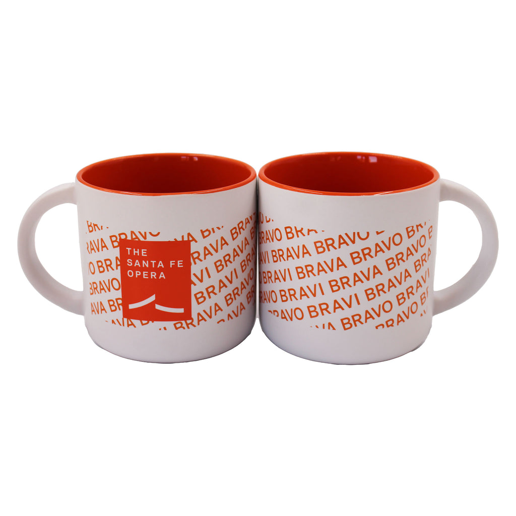 Orange and white mug with orange bravi, bravo, and brava and Santa Fe Opera logo. Inside of mug is also orange.