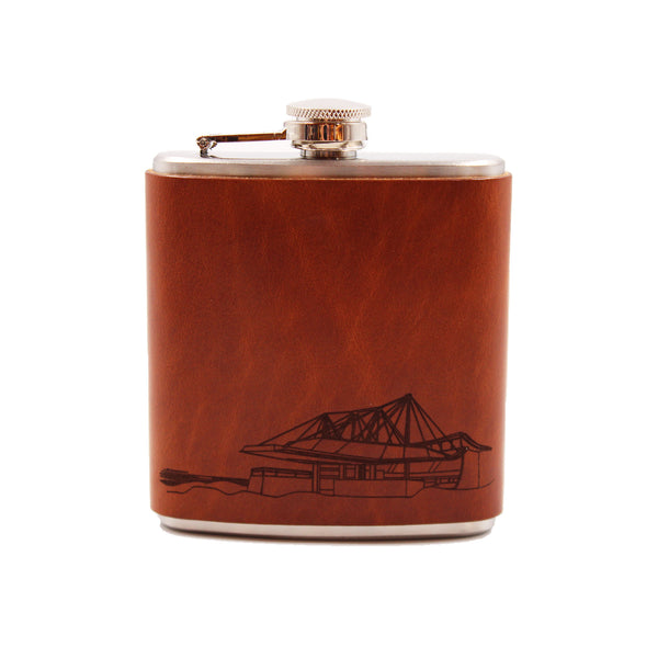 Stainless steal flask, wrapped in brown leather with theater drawing.